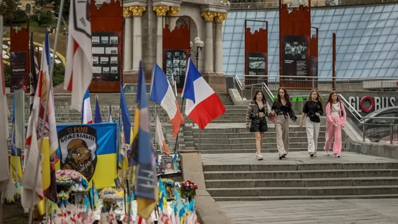 In Ukraine's Independence Square, people pass a makeshift memorial to Ukrainians killed defending the nation