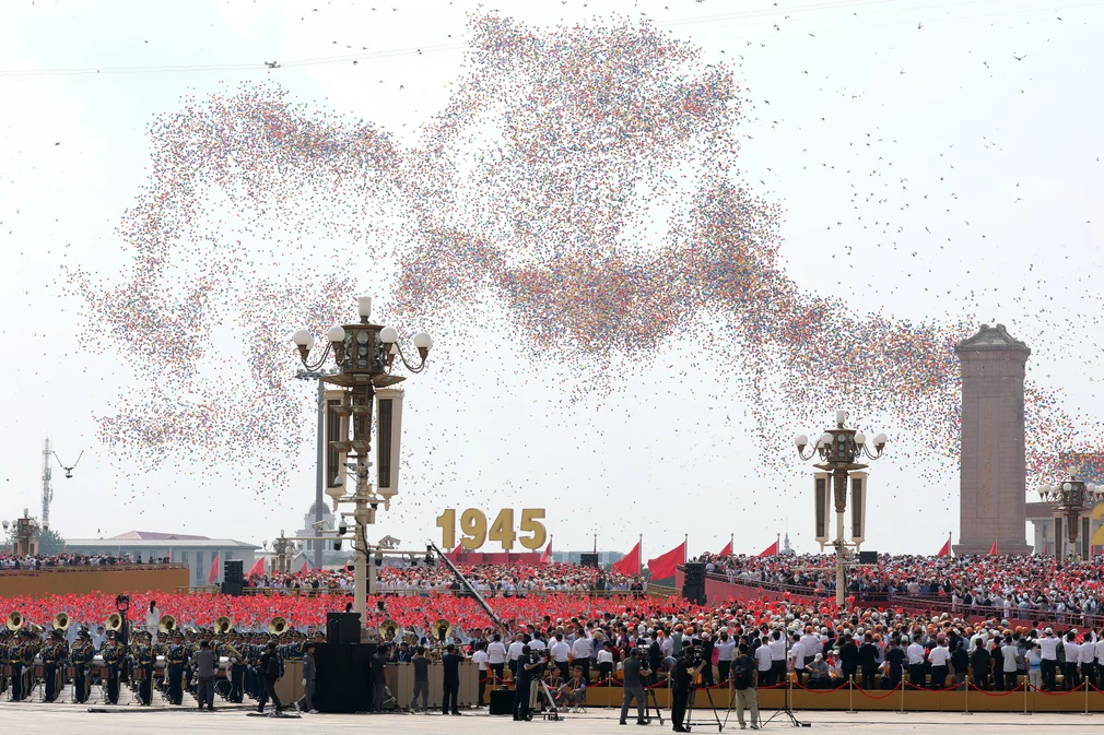 Balloons and doves are released to mark the 80th anniversary of victory over Japan and the end of of the second world war in Tiananmen Square. Photograph: Lintao Zhang/Getty Images