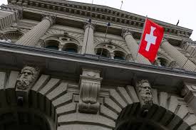 A Swiss flag hangs at the Swiss Parliament building (Bundeshaus) in Bern, Switzerland./Courtesy of Reuters